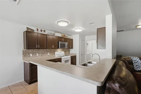 a kitchen with a sink cabinets and stainless steel appliances