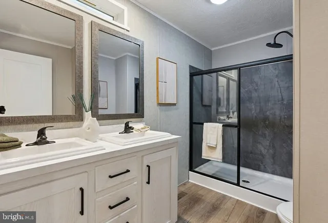 a bathroom with a shower sink and mirror