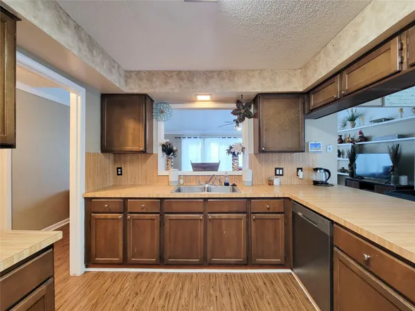 a kitchen with a sink a stove and cabinets