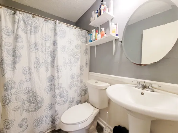 a white toilet sitting next to a bathroom sink