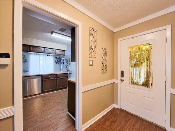 a view of walk in closet with wooden floor and furniture