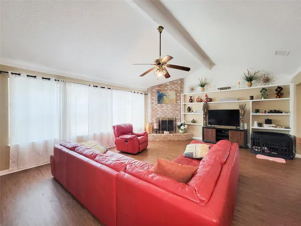 a living room with furniture a flat screen tv and a fireplace