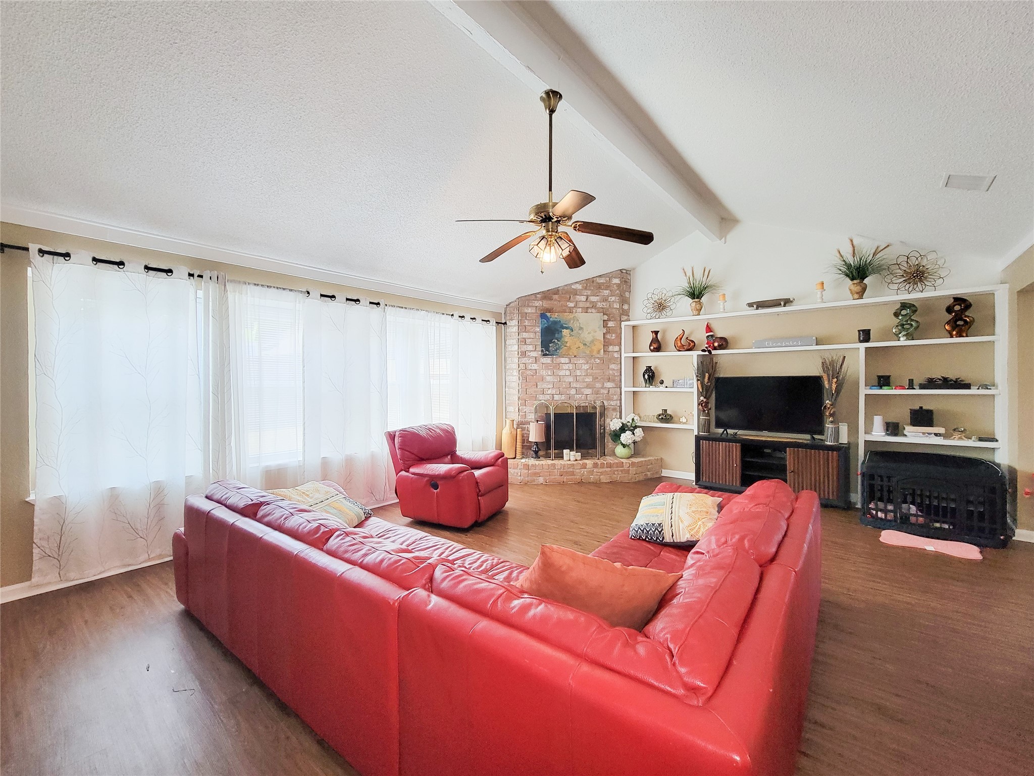 5414 Sweetwind Lane Spring, TX 77373 - Photo 22 of 30 a living room with furniture a flat screen tv and a fireplace