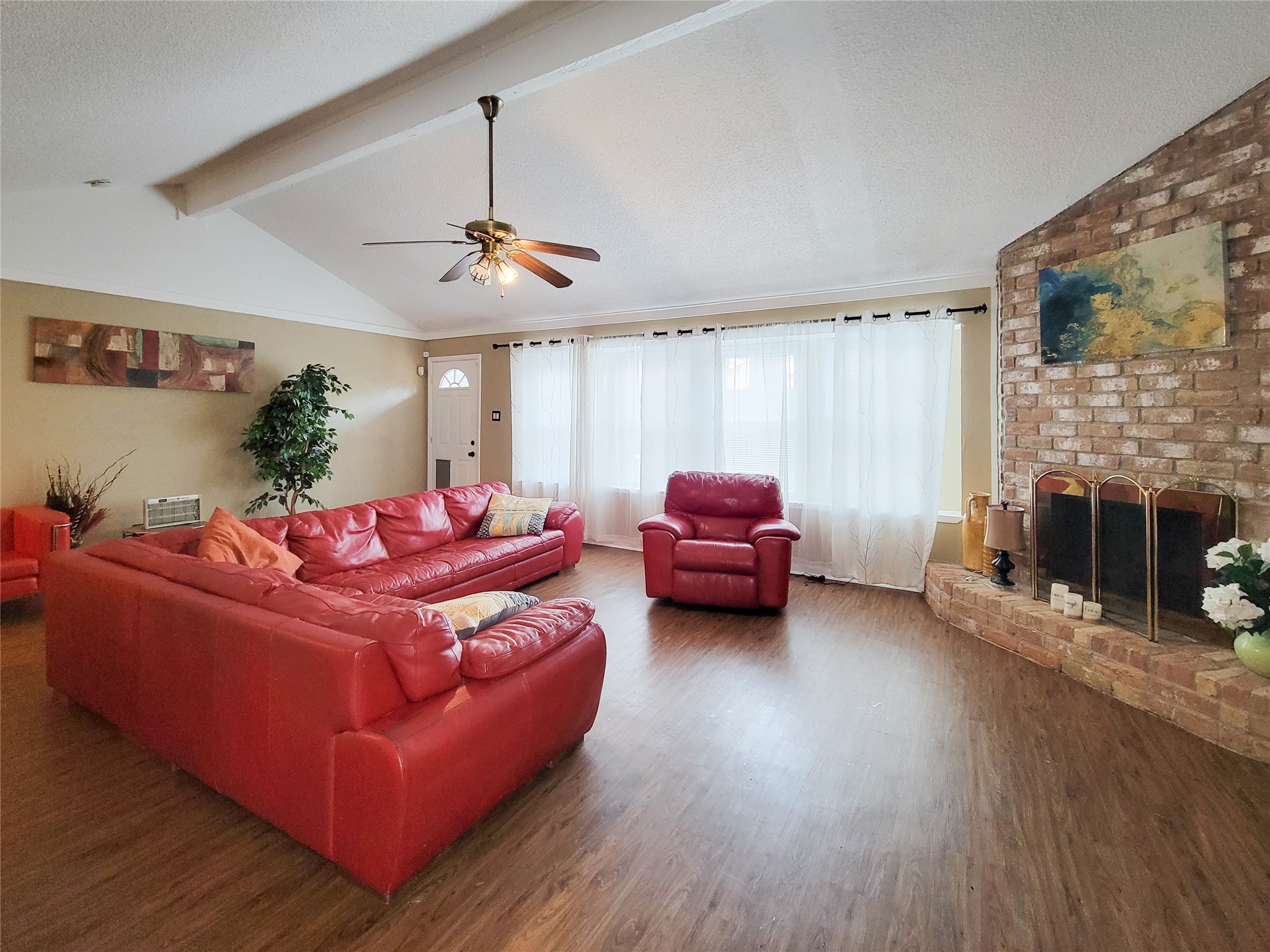 5414 Sweetwind Lane Spring, TX 77373 - Photo 24 of 30 a living room with furniture a fireplace and a flat screen tv
