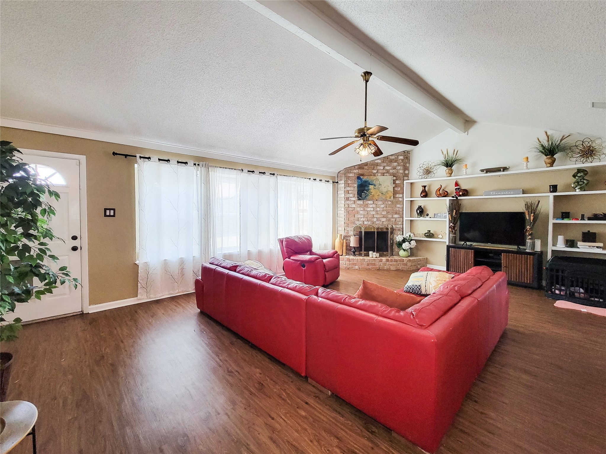 5414 Sweetwind Lane Spring, TX 77373 - Photo 25 of 30 a living room with furniture a fireplace and a potted plant