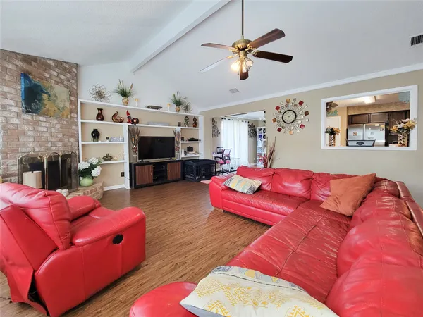 a living room with furniture a flat screen tv and a fireplace