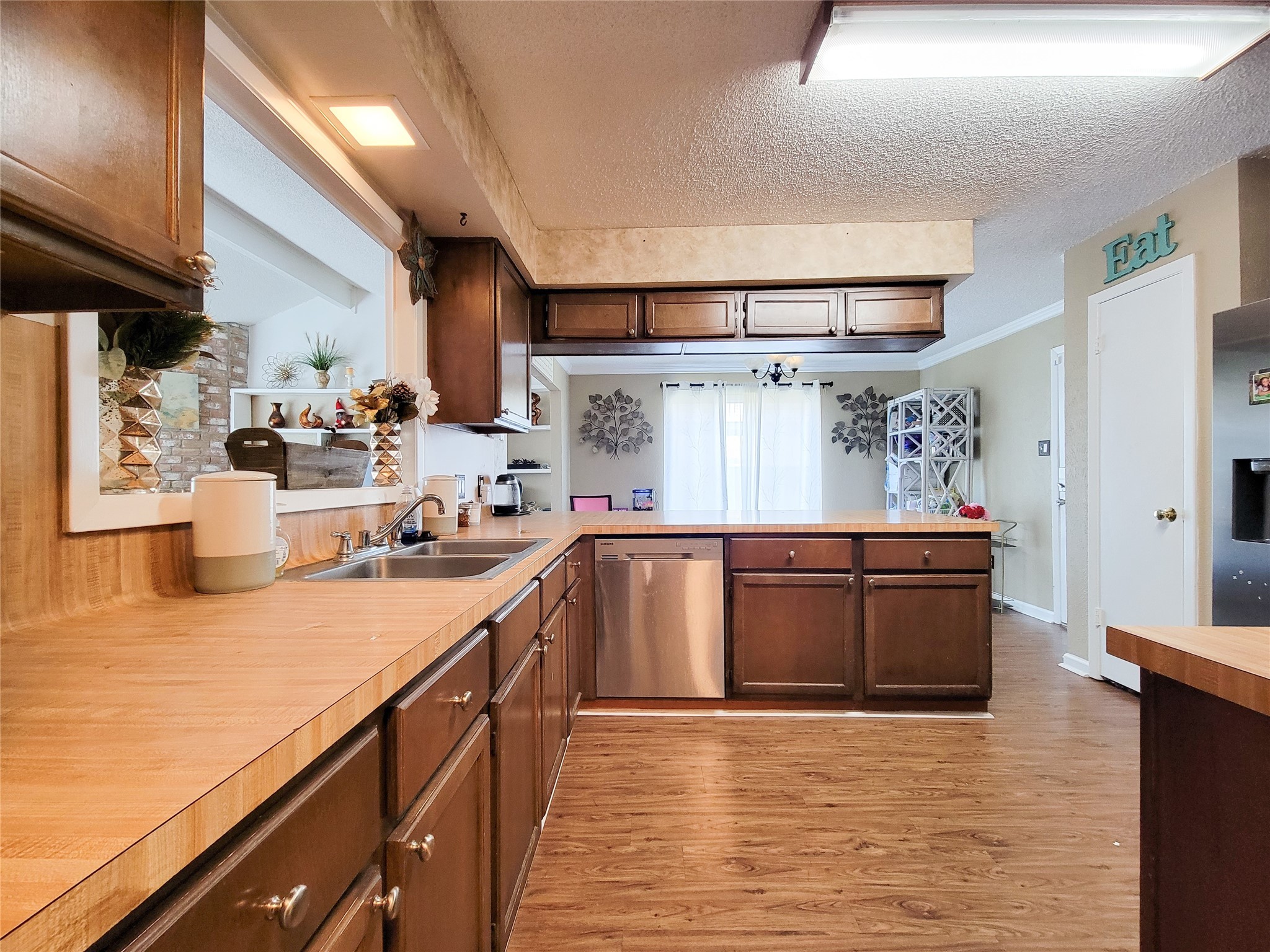 5414 Sweetwind Lane Spring, TX 77373 - Photo 5 of 30 a kitchen with stainless steel appliances granite countertop a sink dishwasher stove and wooden cabinets