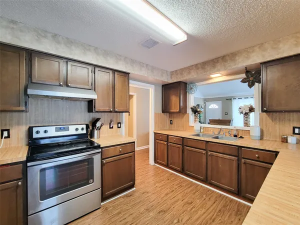 a kitchen with stainless steel appliances a stove sink and cabinets