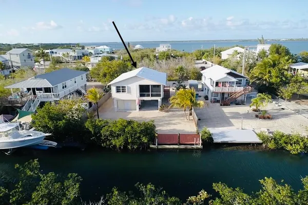 an aerial view of a house with a lake view