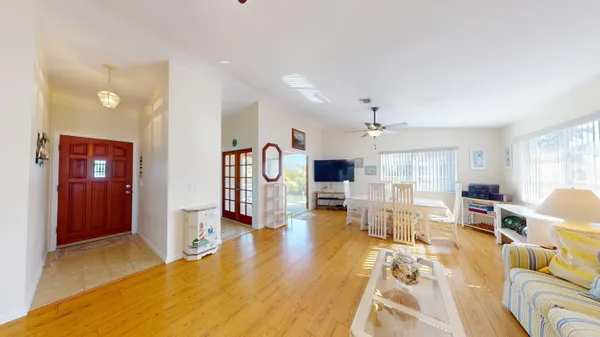 a view of a hallway with a livingroom and a bathroom with bathtub
