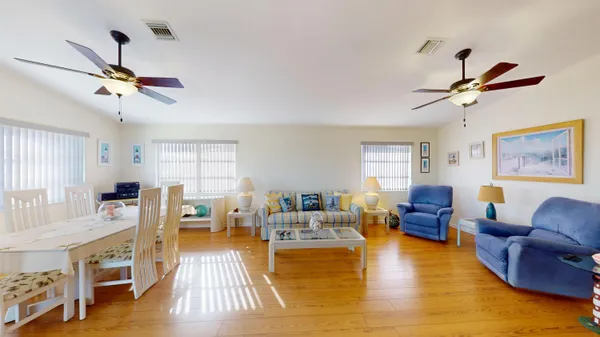 a bedroom with two beds and a dresser with wooden floor