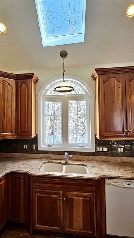 16 Arbor Road, Unit 16 Dracut, MA 01826 - Photo 3 of 13 a kitchen with stainless steel appliances granite countertop a stove a sink and a microwave
