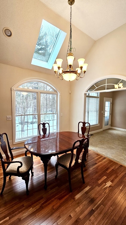 16 Arbor Road, Unit 16 Dracut, MA 01826 - Photo 4 of 13 a view of a dining room with furniture wooden floor and chandelier