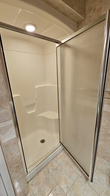 16 Arbor Road, Unit 16 Dracut, MA 01826 - Photo 9 of 13 a bathroom with a glass shower door