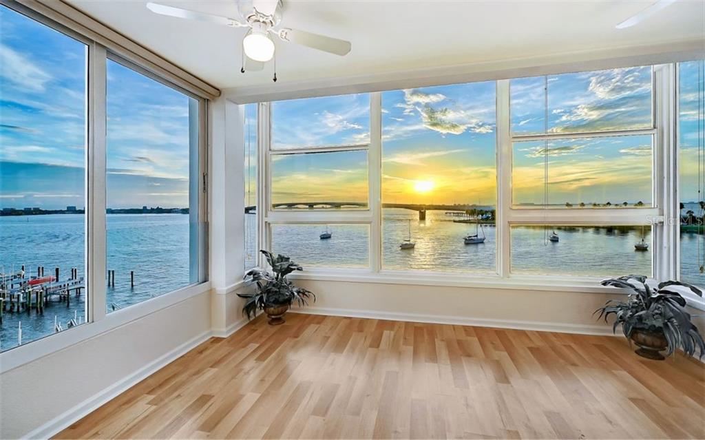 a view of a living room and floor to ceiling window or wooden floor