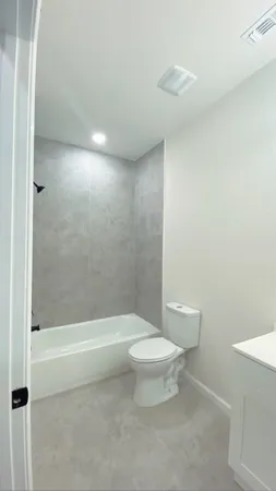 a bathroom with a toilet a sink and shower