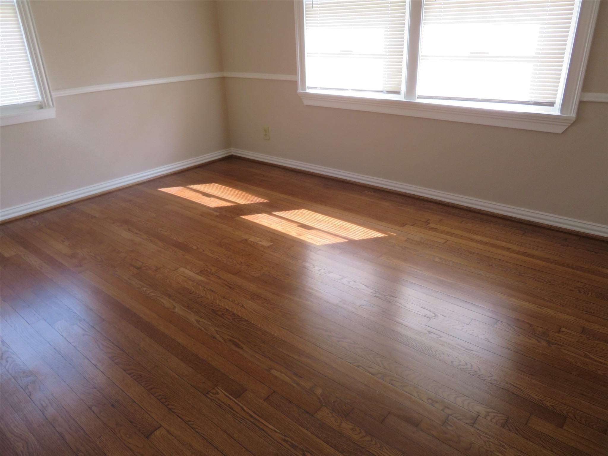 5818 Carew Street Houston, TX 77074 - Photo 11 of 16 an empty room with wooden floor and windows