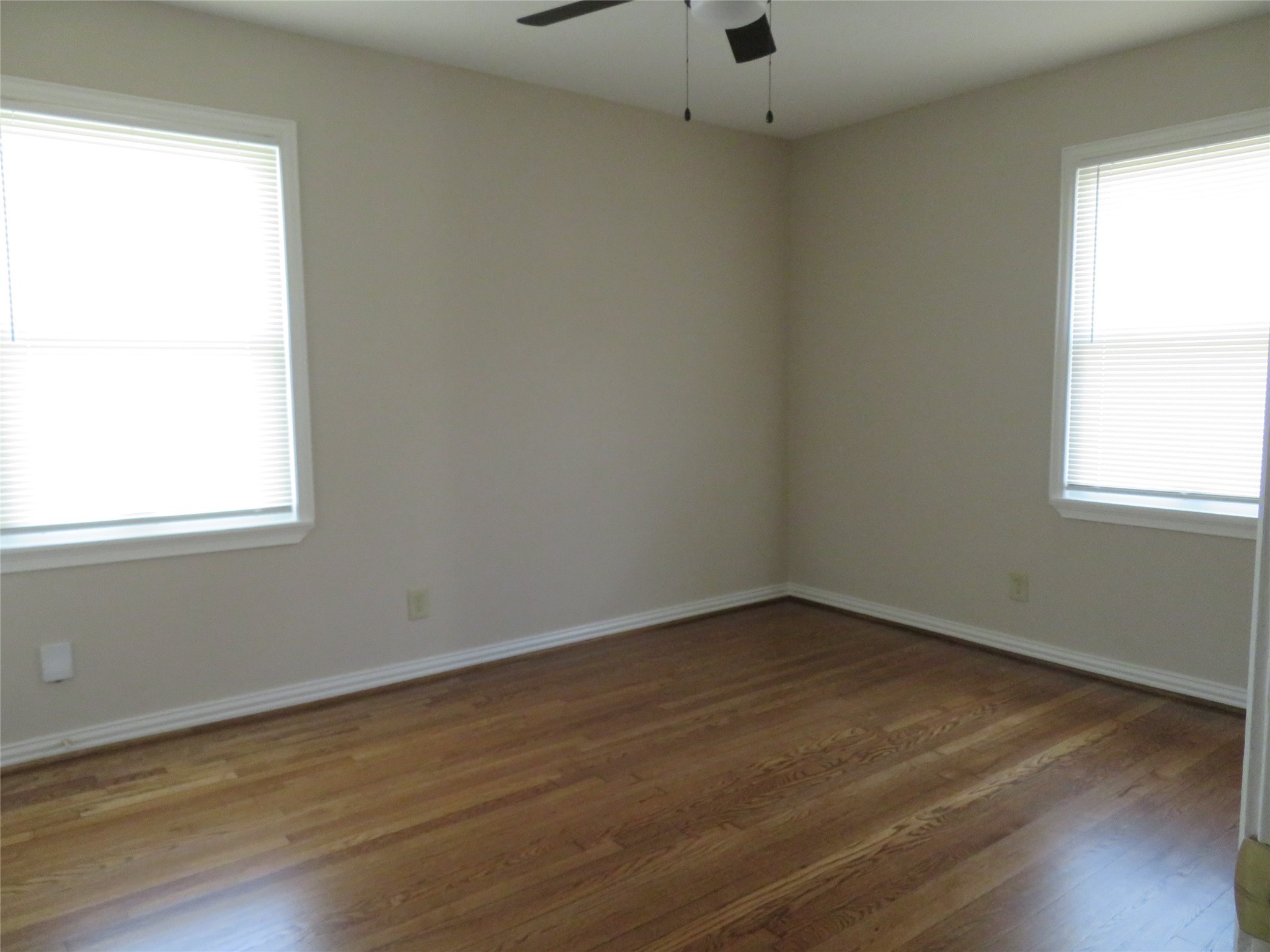 5818 Carew Street Houston, TX 77074 - Photo 12 of 16 an empty room with wooden floor and windows