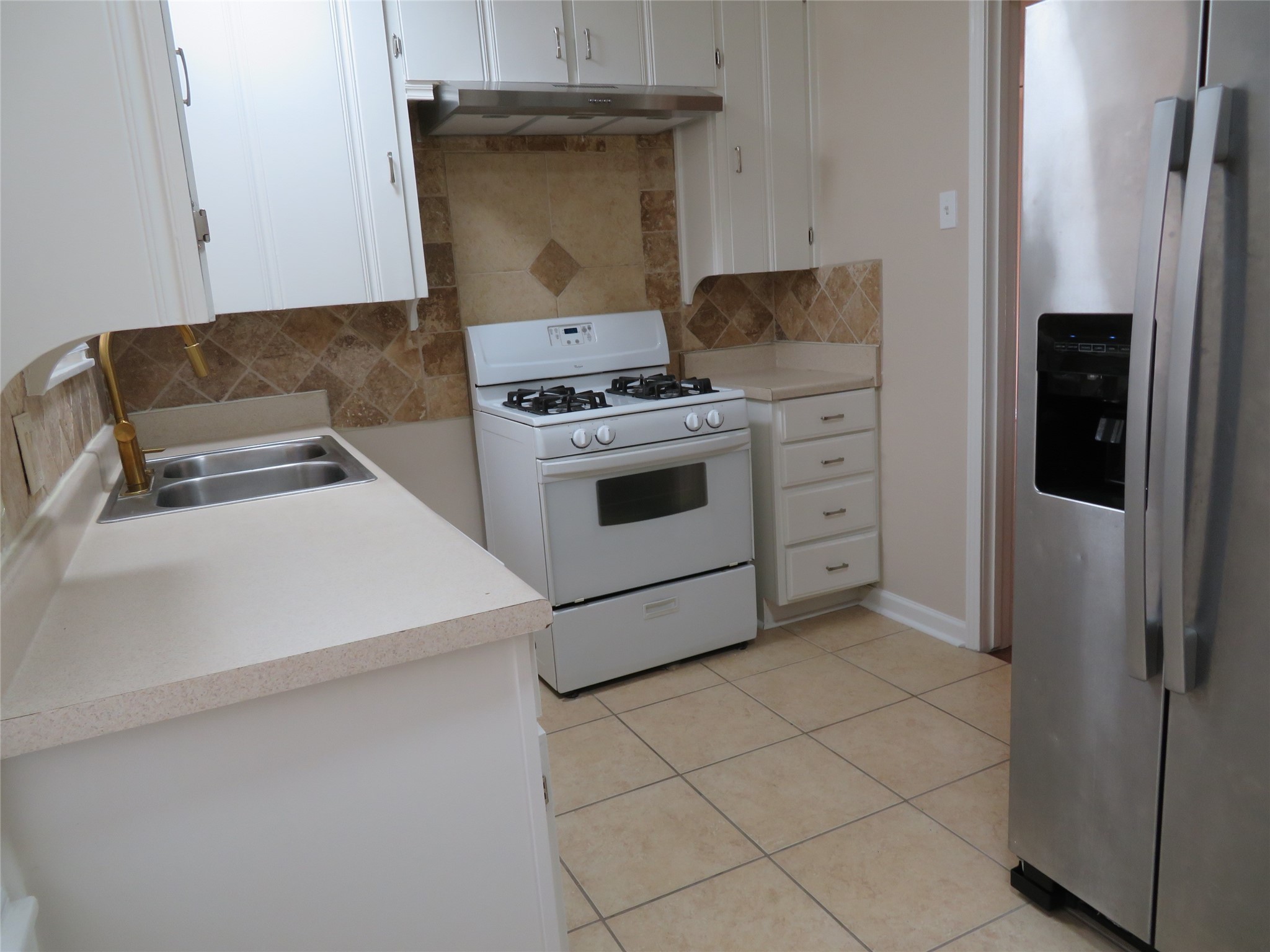 5818 Carew Street Houston, TX 77074 - Photo 5 of 16 a kitchen with a stove and a refrigerator