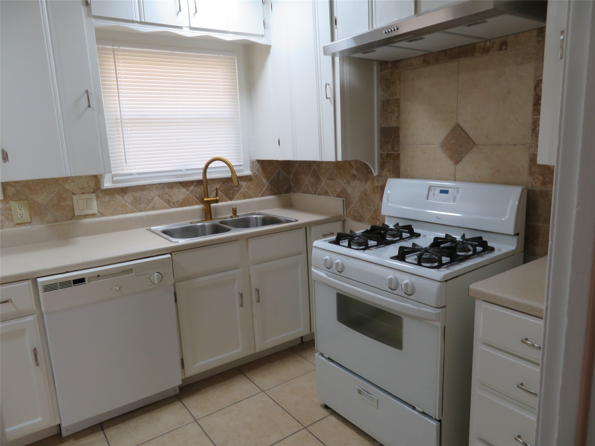 5818 Carew Street Houston, TX 77074 - Photo 6 of 16 a white stove top oven sitting inside of a kitchen