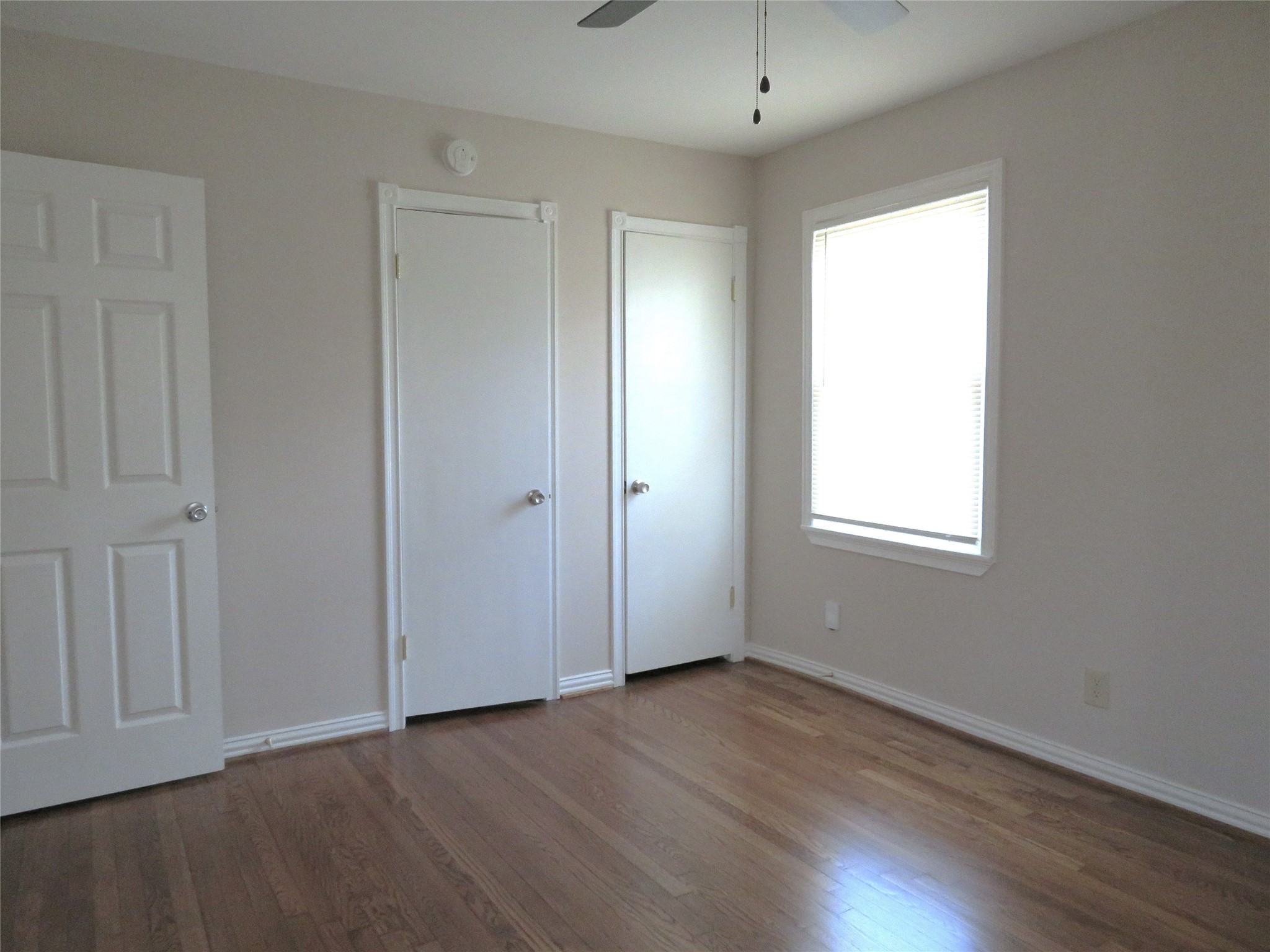 5818 Carew Street Houston, TX 77074 - Photo 9 of 16 an empty room with wooden floor and windows