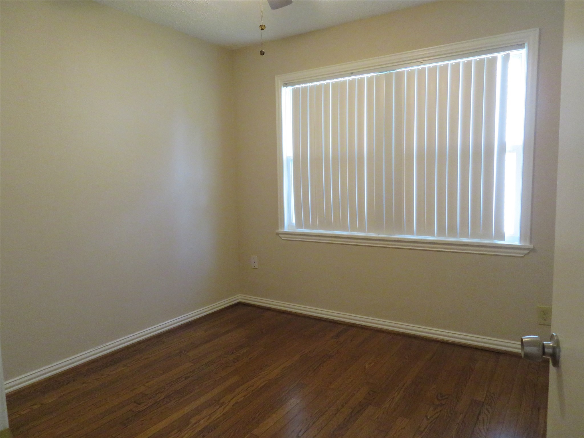 5818 Carew Street Houston, TX 77074 - Photo 10 of 16 a view of a small space with wooden floor and a window