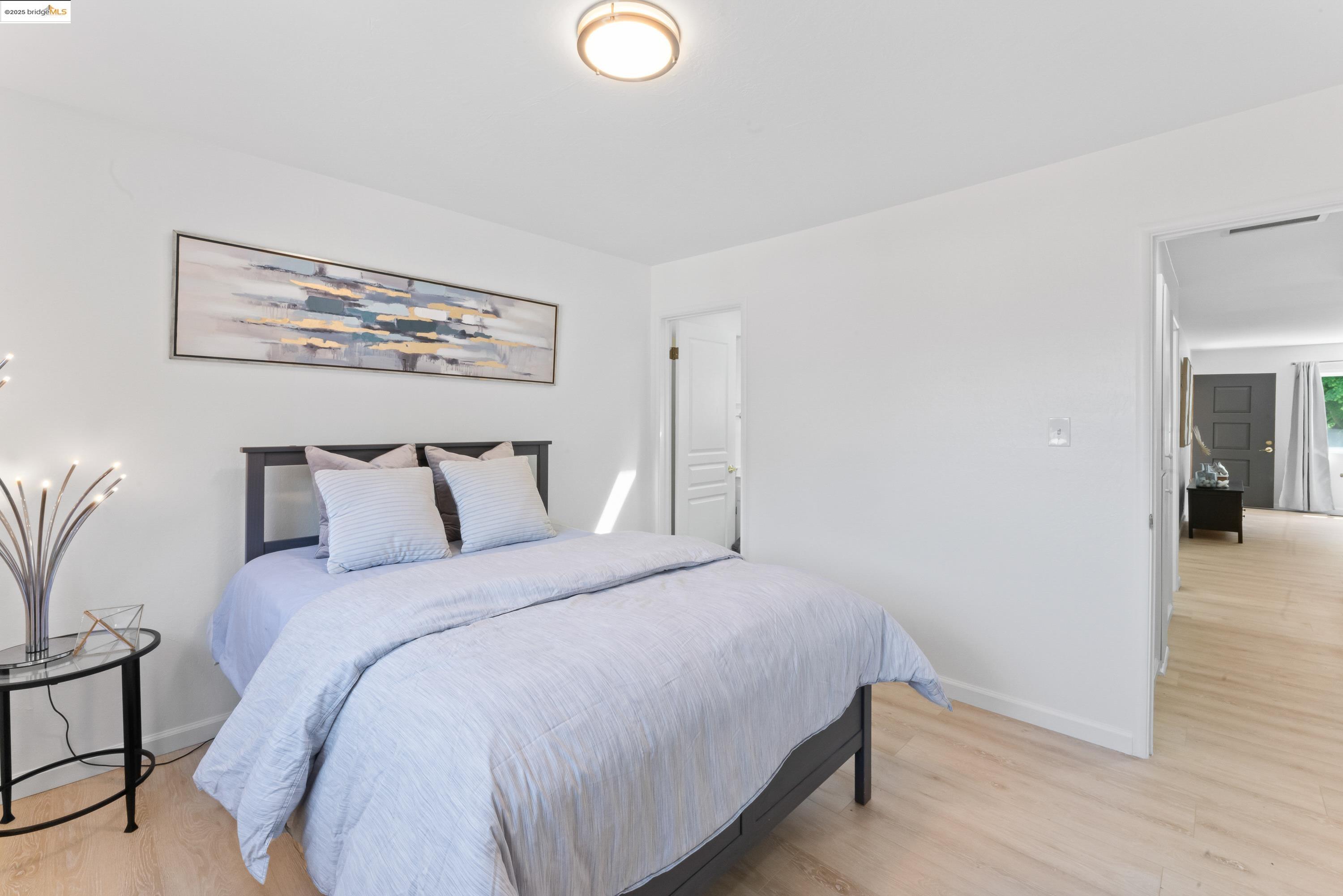 2305 Marlin Court Pinole, CA 94564 - Photo 13 of 31 a bedroom with a bed and wooden floor