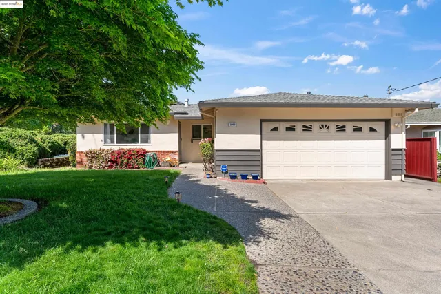 a view of a house with a yard and garage