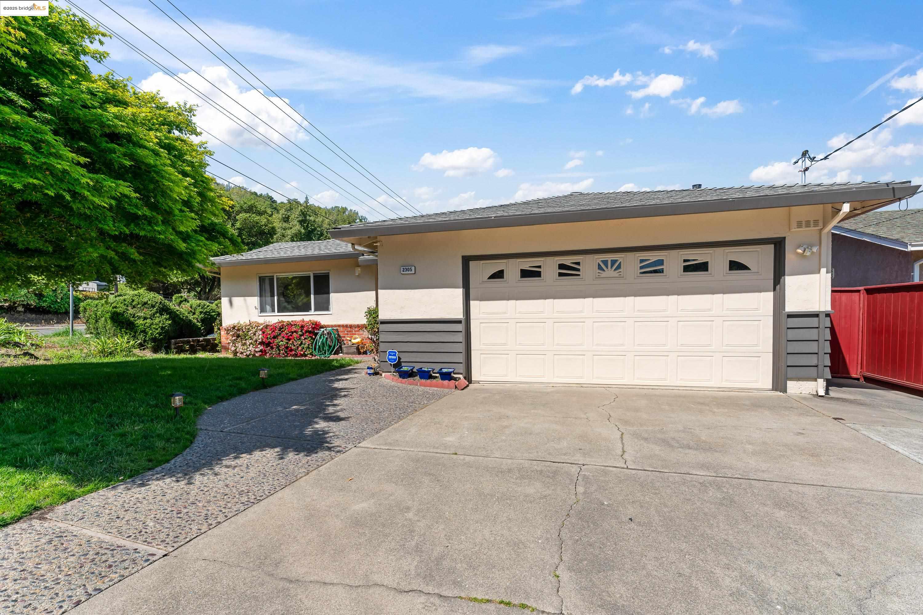 2305 Marlin Court Pinole, CA 94564 - Photo 23 of 31 a view of a house with a yard and garage