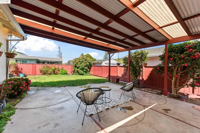 a view of a backyard with plants and a patio