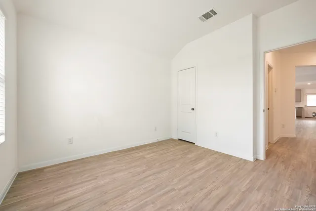 an empty room with wooden floor