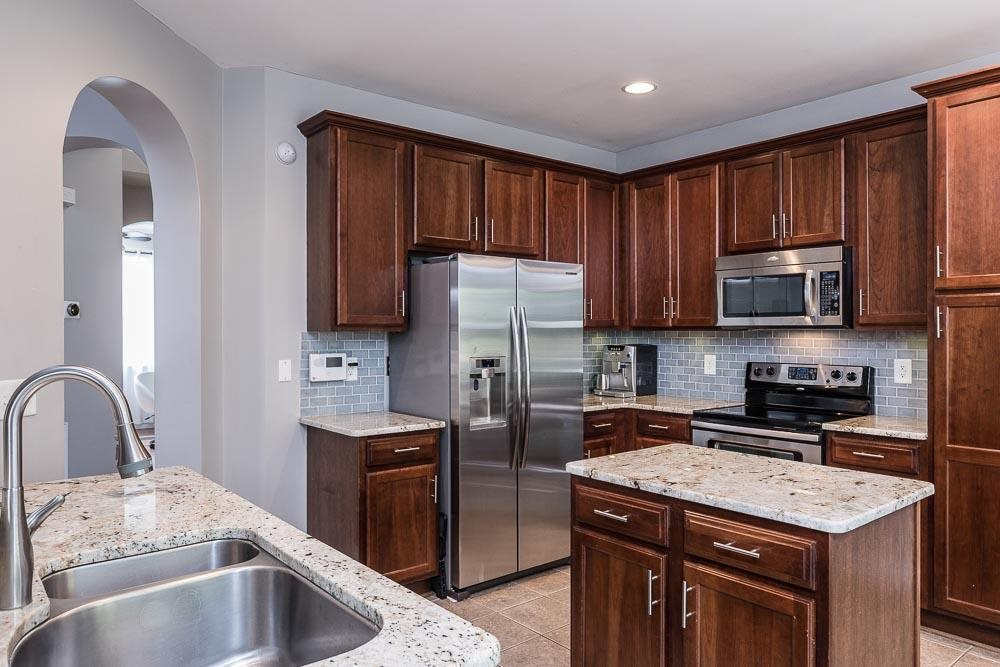 8305 Chimneycap Drive Raleigh, NC 27613 - Photo 6 of 30 A chef's dream to work on these high end granite counters in a well planned layout! Kitchen