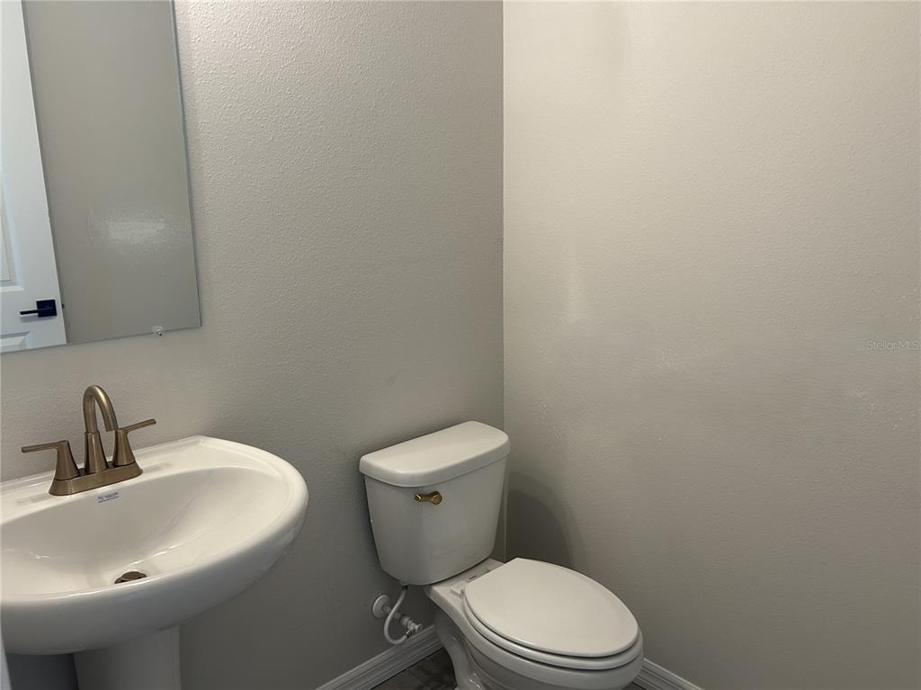 10026 Hidden Hammock Loop Parrish, FL 34221 - Photo 18 of 34 a white toilet sitting next to a bathroom sink
