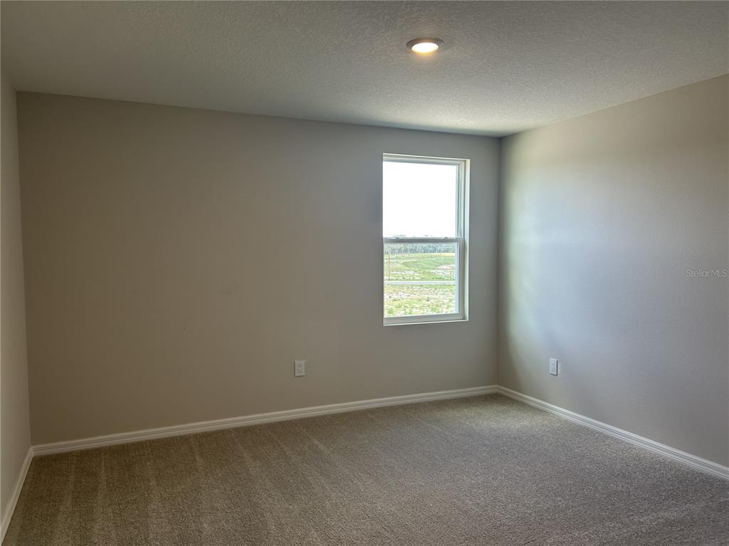 10026 Hidden Hammock Loop Parrish, FL 34221 - Photo 26 of 34 an empty room with a window