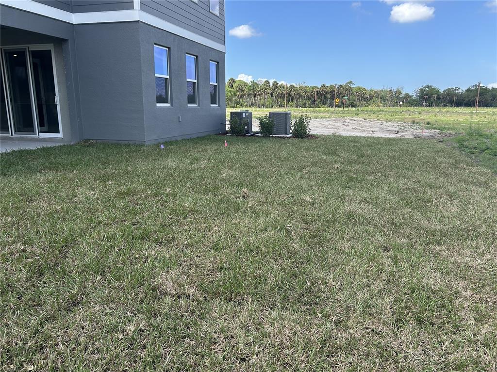 10026 Hidden Hammock Loop Parrish, FL 34221 - Photo 33 of 34 a view of a house with a yard