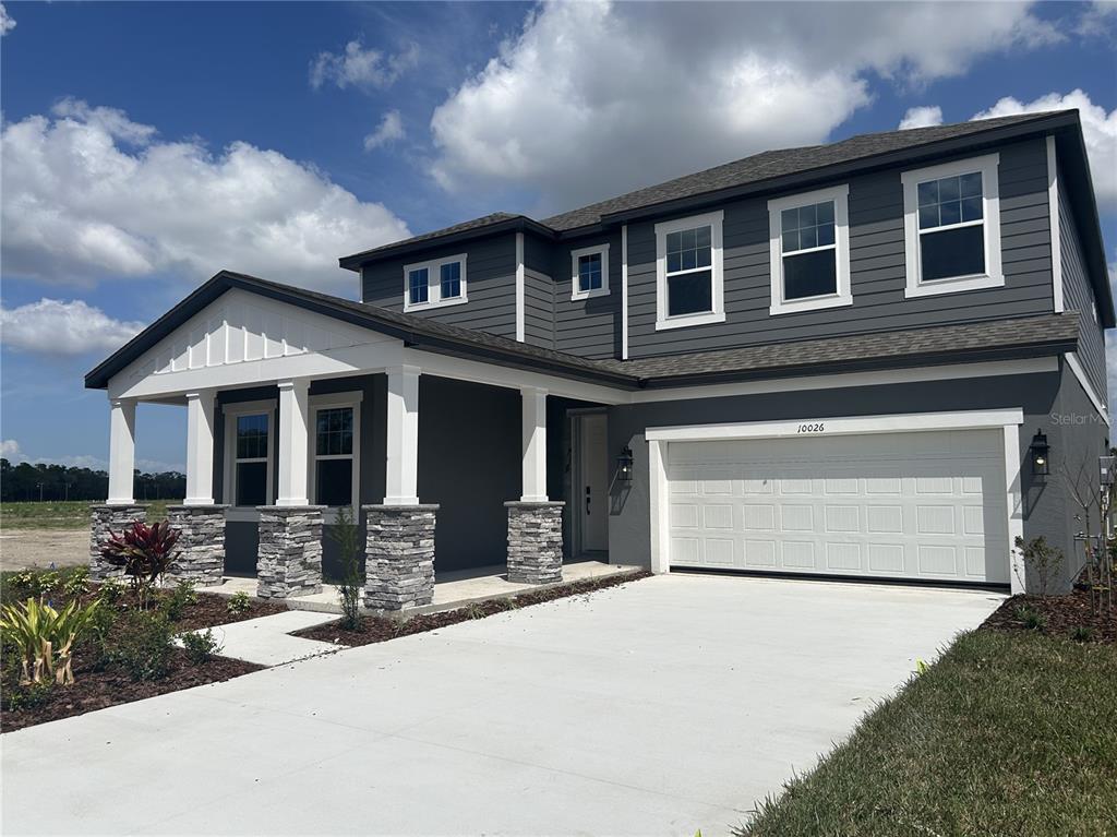10026 Hidden Hammock Loop Parrish, FL 34221 - Photo 6 of 34 a front view of a house with yard and parking
