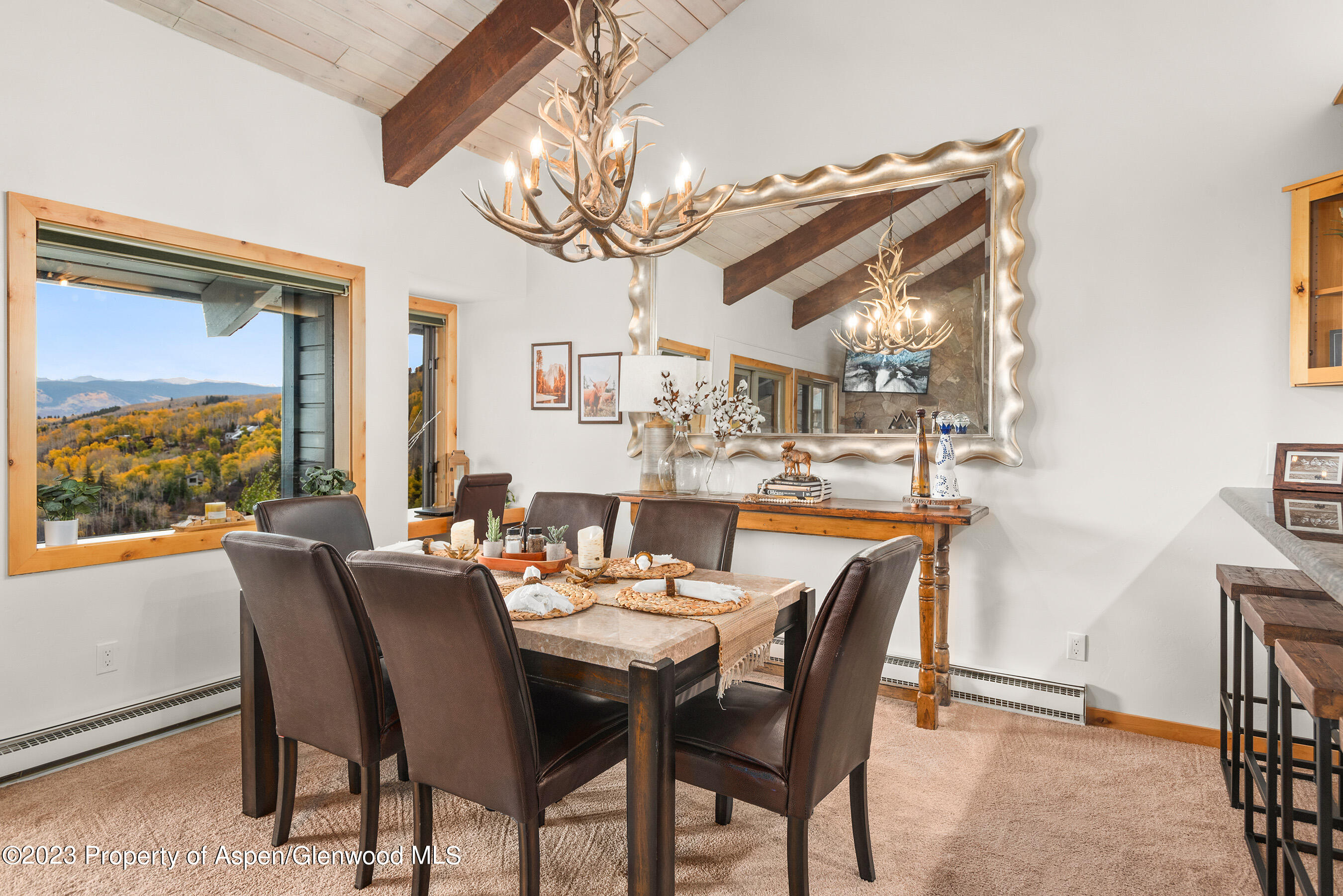 55 Upper Woodbridge Road, Unit G3 Snowmass Village, CO 81615 - Photo 12 of 44 a dining room with wooden floor a chandelier a wooden table and chairs