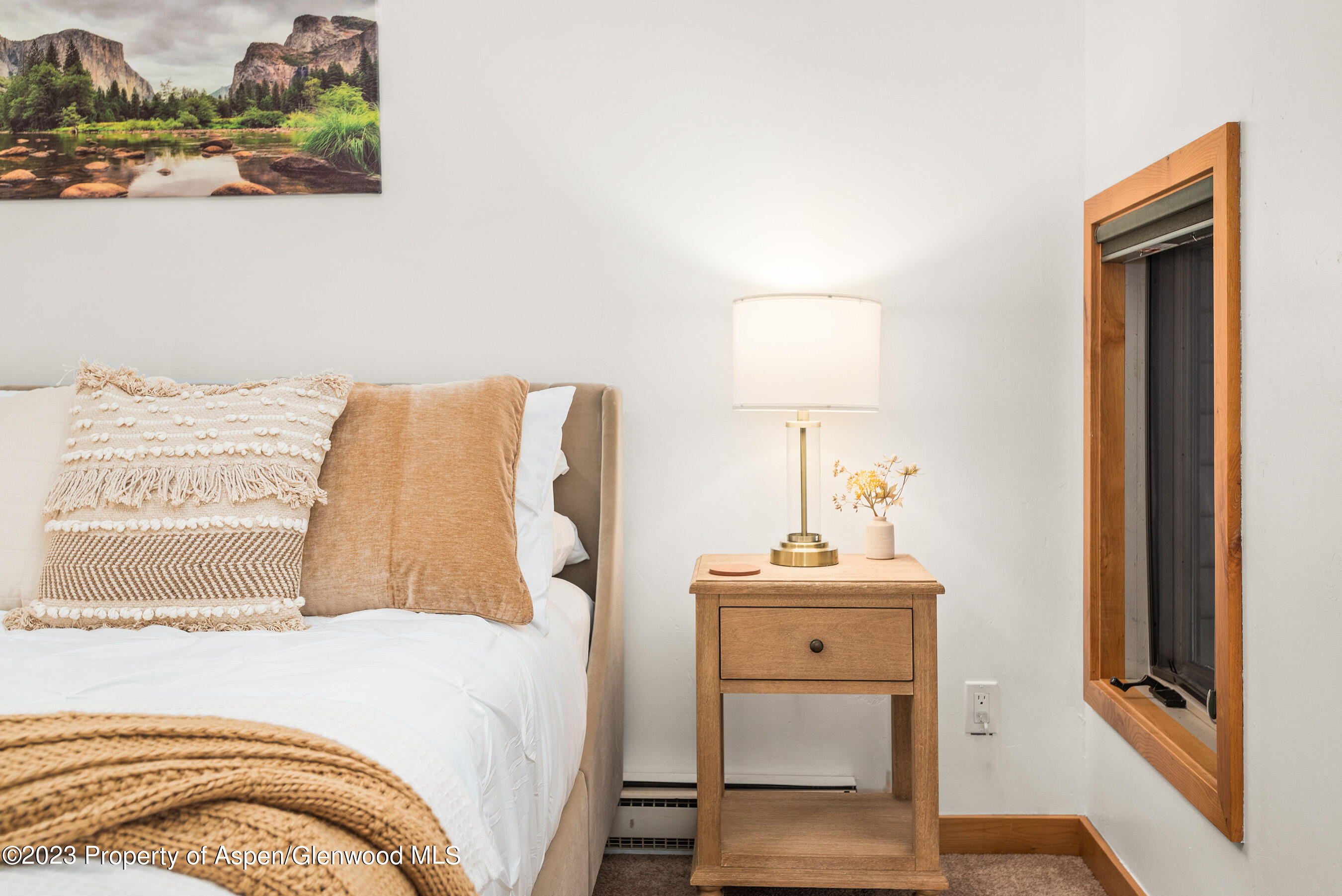 55 Upper Woodbridge Road, Unit G3 Snowmass Village, CO 81615 - Photo 18 of 44 a bedroom with a bed and a table