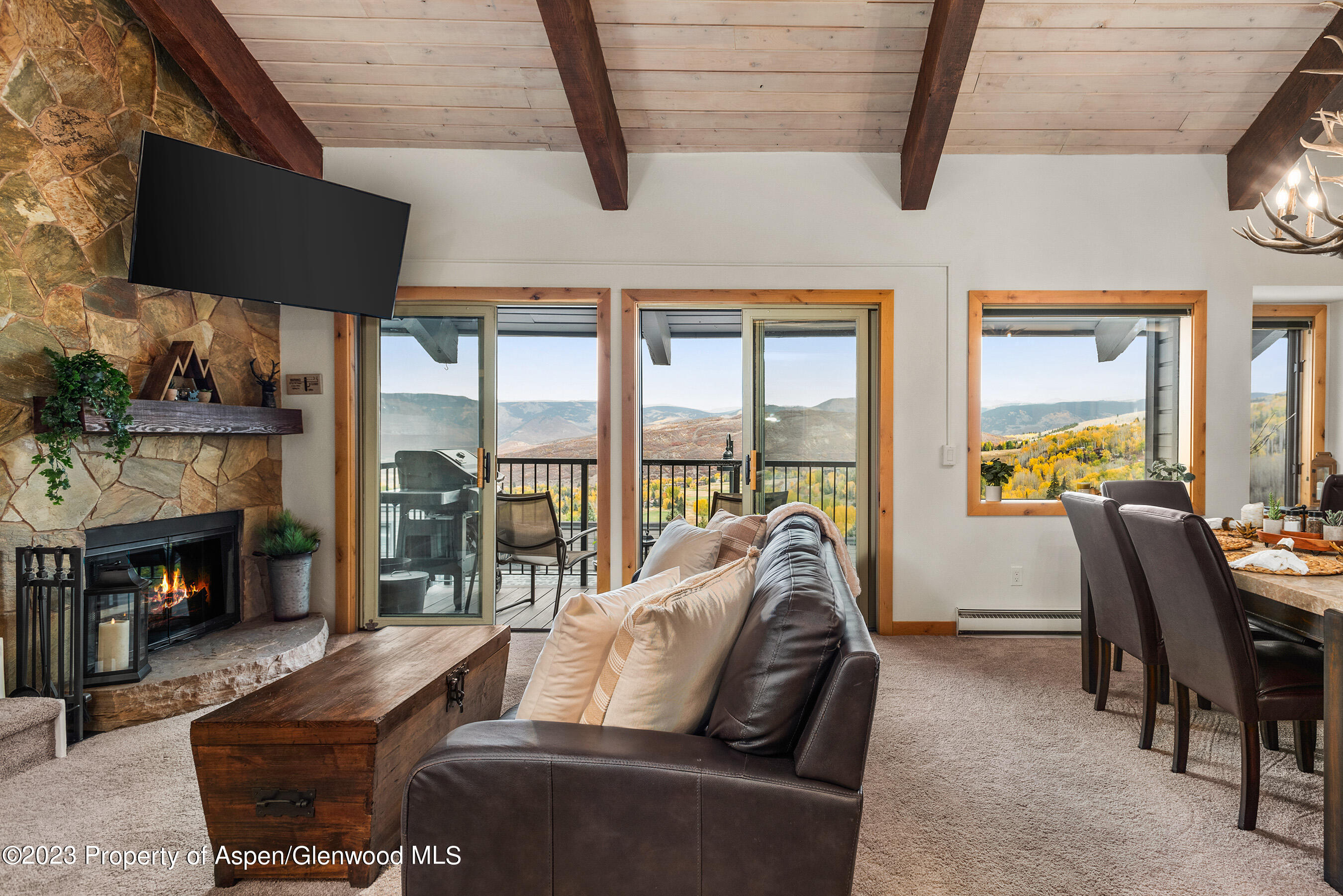55 Upper Woodbridge Road, Unit G3 Snowmass Village, CO 81615 - Photo 3 of 44 a living room with furniture and a fireplace