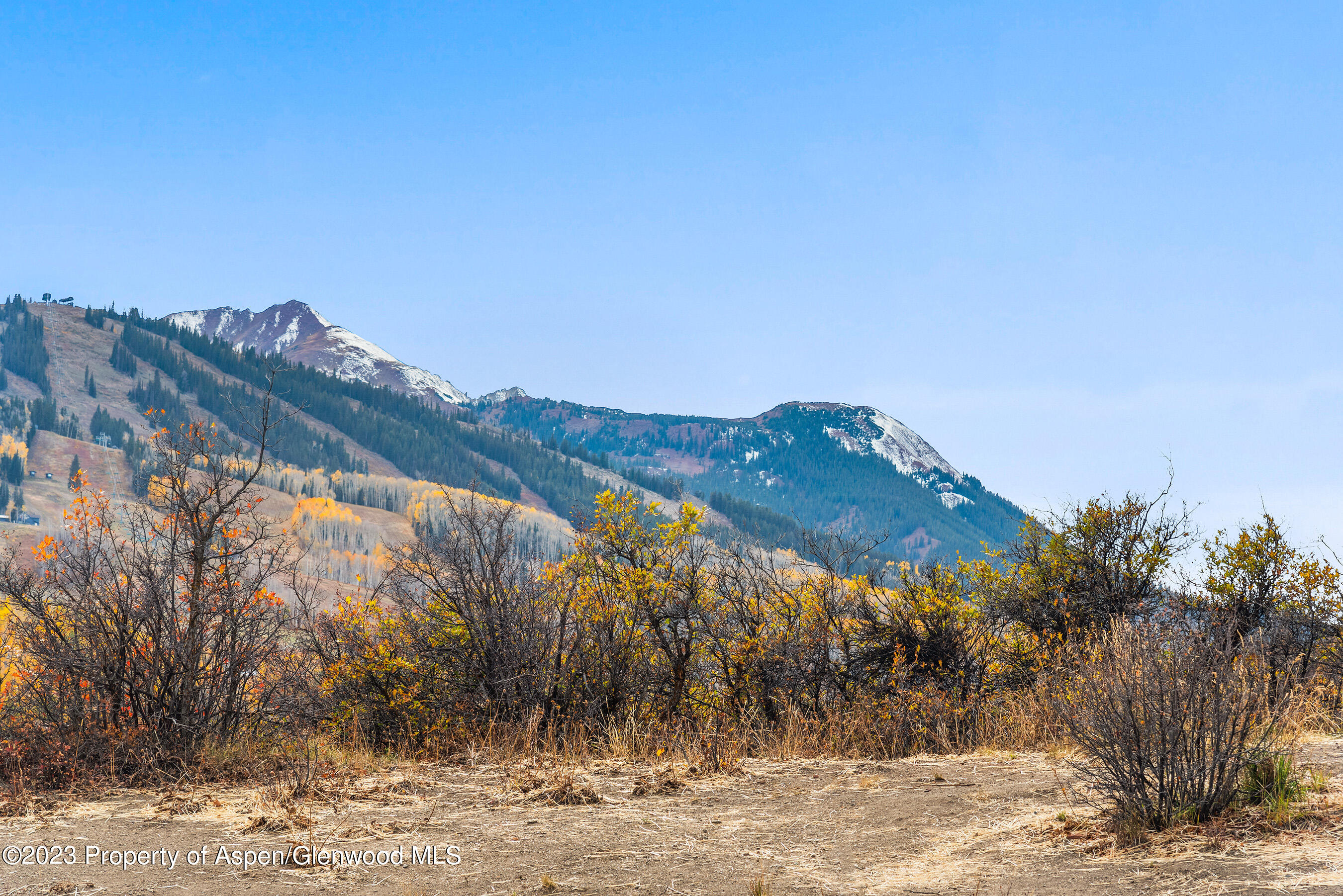 55 Upper Woodbridge Road, Unit G3 Snowmass Village, CO 81615 - Photo 35 of 44 a view of a large building with a mountain in the background