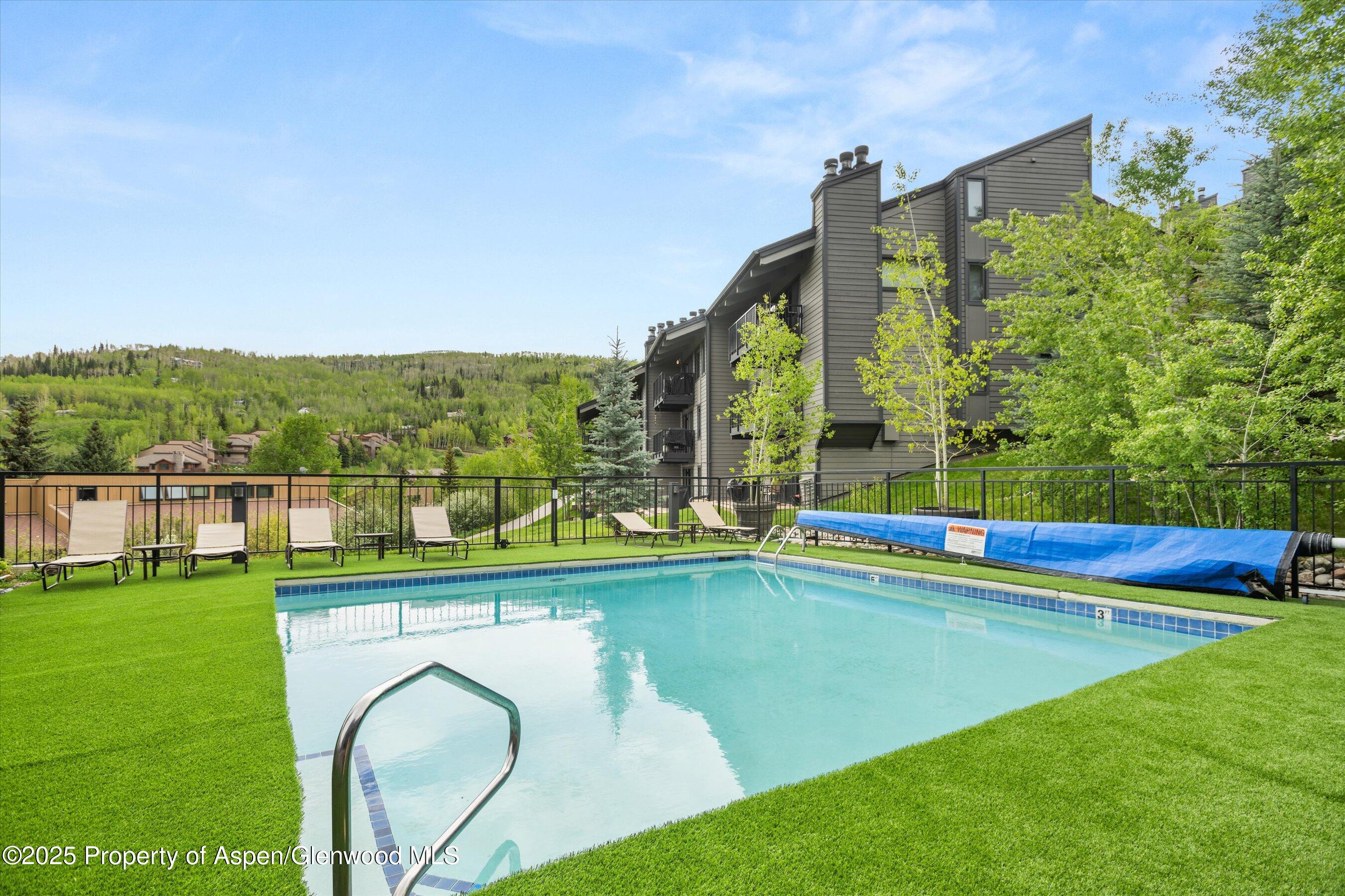 55 Upper Woodbridge Road, Unit G3 Snowmass Village, CO 81615 - Photo 44 of 44 a view of swimming pool with a garden and lake view