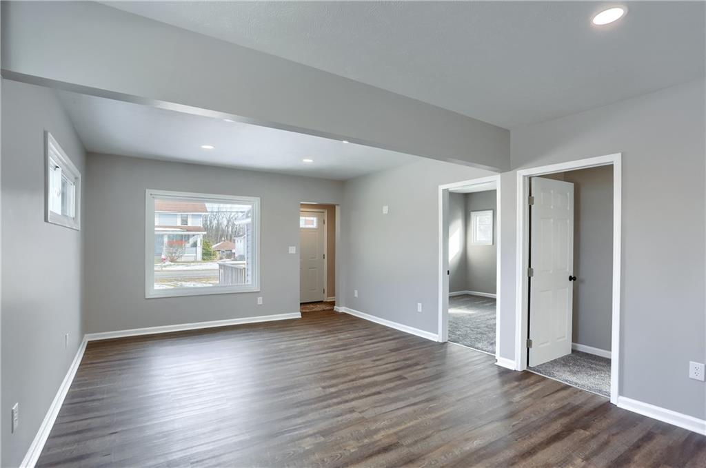 1524 Old Butler Road New Castle, PA 16101 - Photo 4 of 28 an empty room with wooden floor mirror and windows
