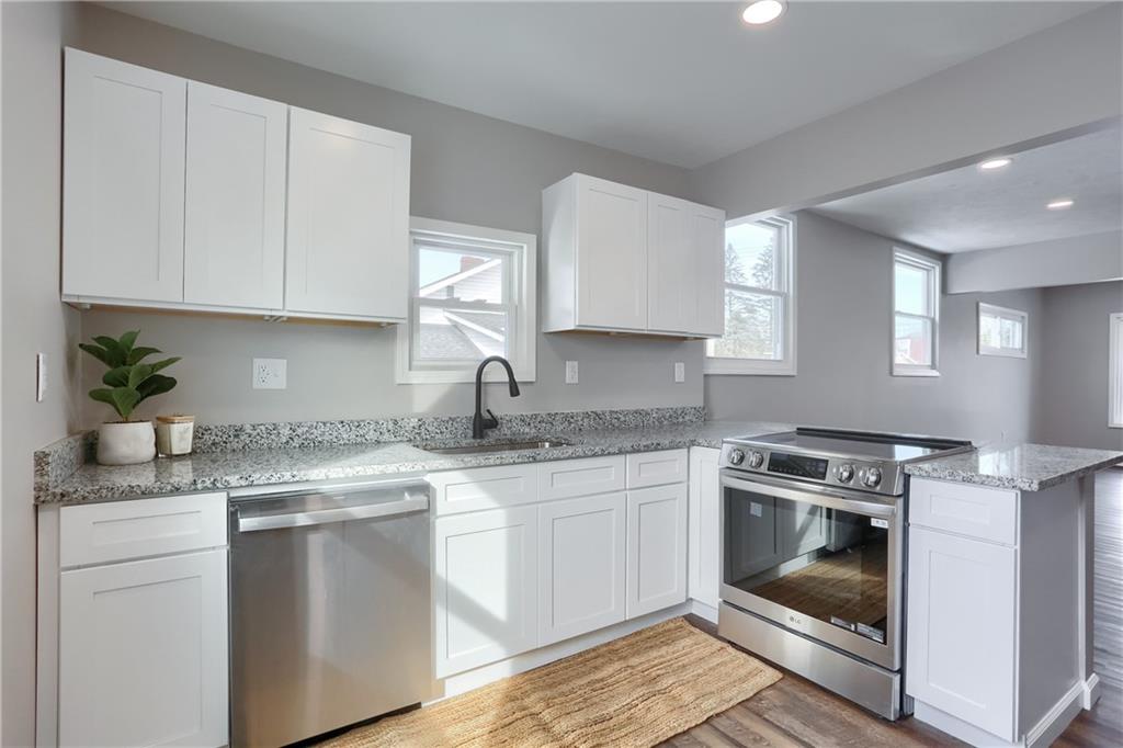 1524 Old Butler Road New Castle, PA 16101 - Photo 8 of 28 a kitchen with granite countertop white cabinets and white appliances