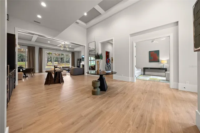 a living room with furniture large window and flat screen tv