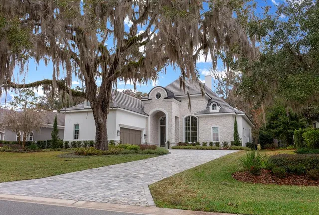 a view of kitchen with refrigerator stove and wooden cabinets