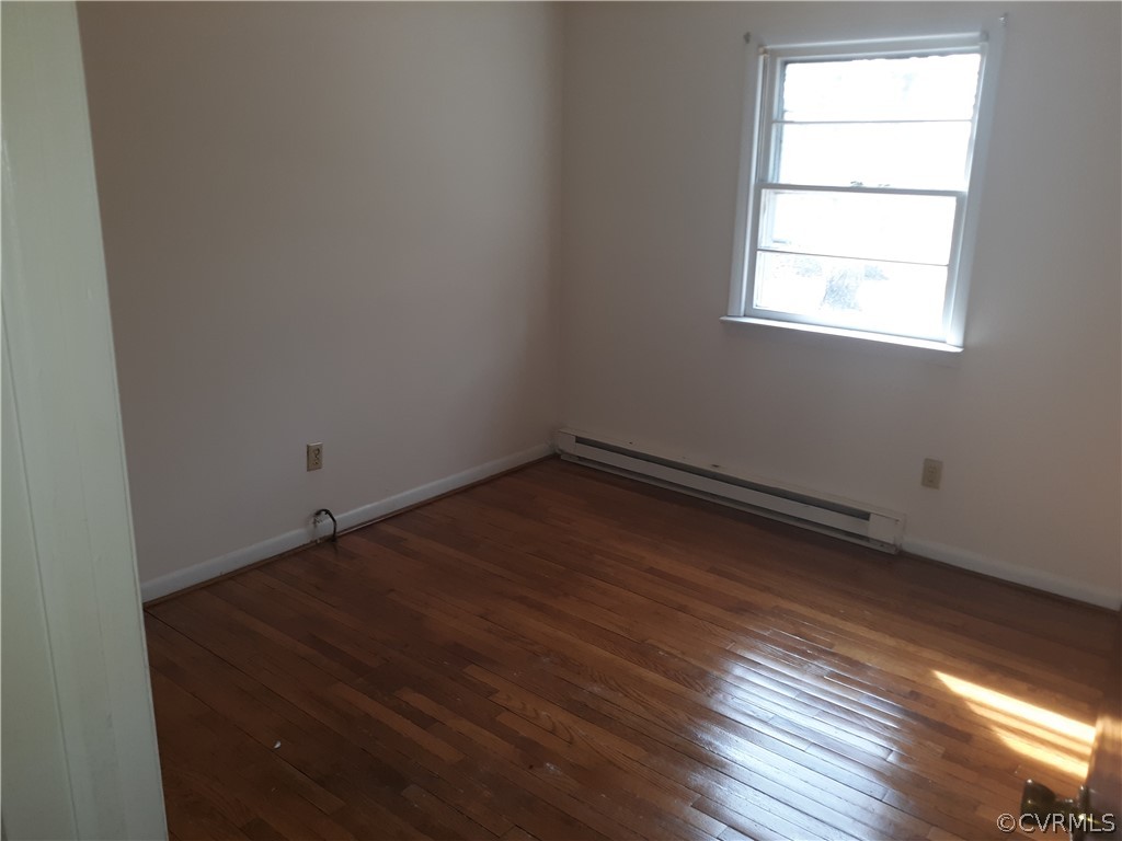 244 Bradley Farm Road Newtown, VA 23126 - Photo 11 of 14 an empty room with wooden floor and windows