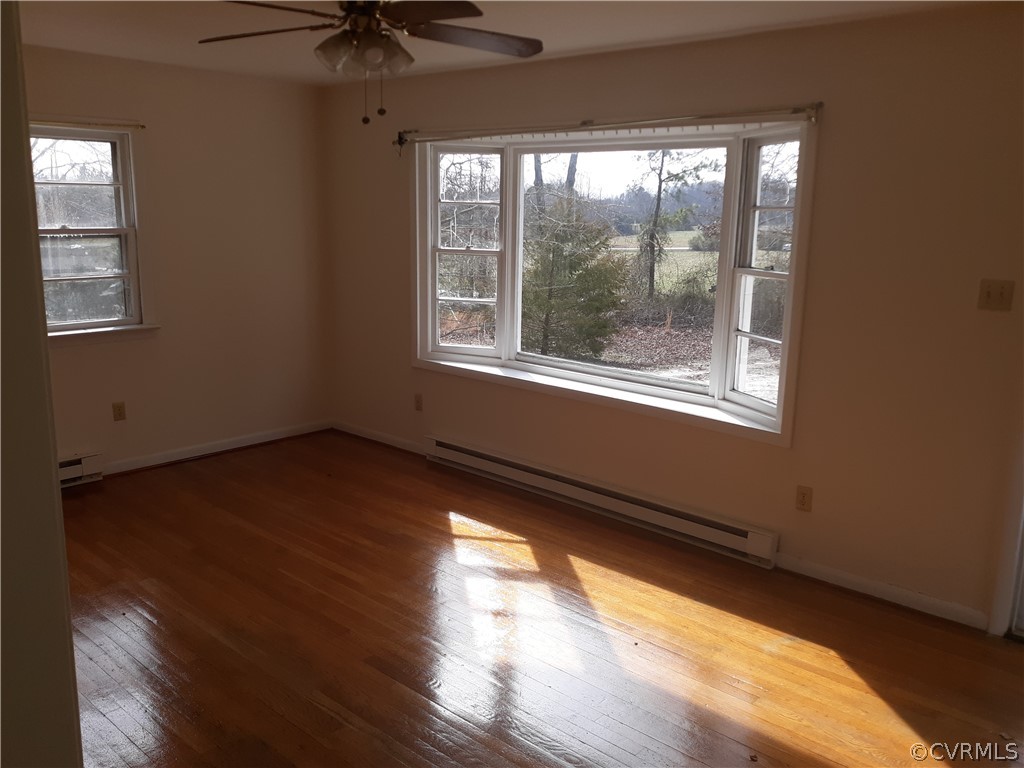 244 Bradley Farm Road Newtown, VA 23126 - Photo 14 of 14 a view of an empty room with wooden floor and a window