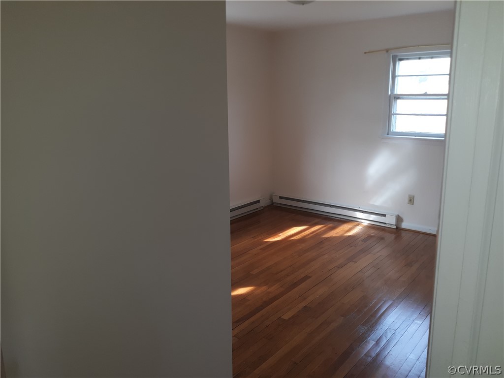 244 Bradley Farm Road Newtown, VA 23126 - Photo 5 of 14 an empty room with wooden floor and windows