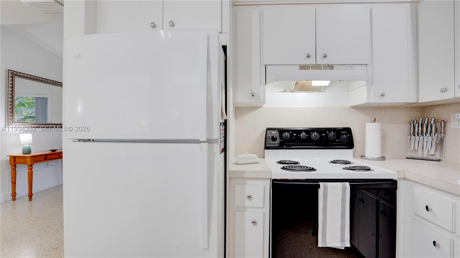 2905 Southwest 93rd Court Miami, FL 33165 - Photo 17 of 46 a refrigerator freezer sitting in a kitchen with white cabinets