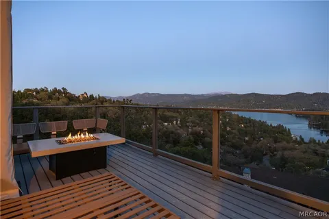 a view of a balcony with wooden floor and city view